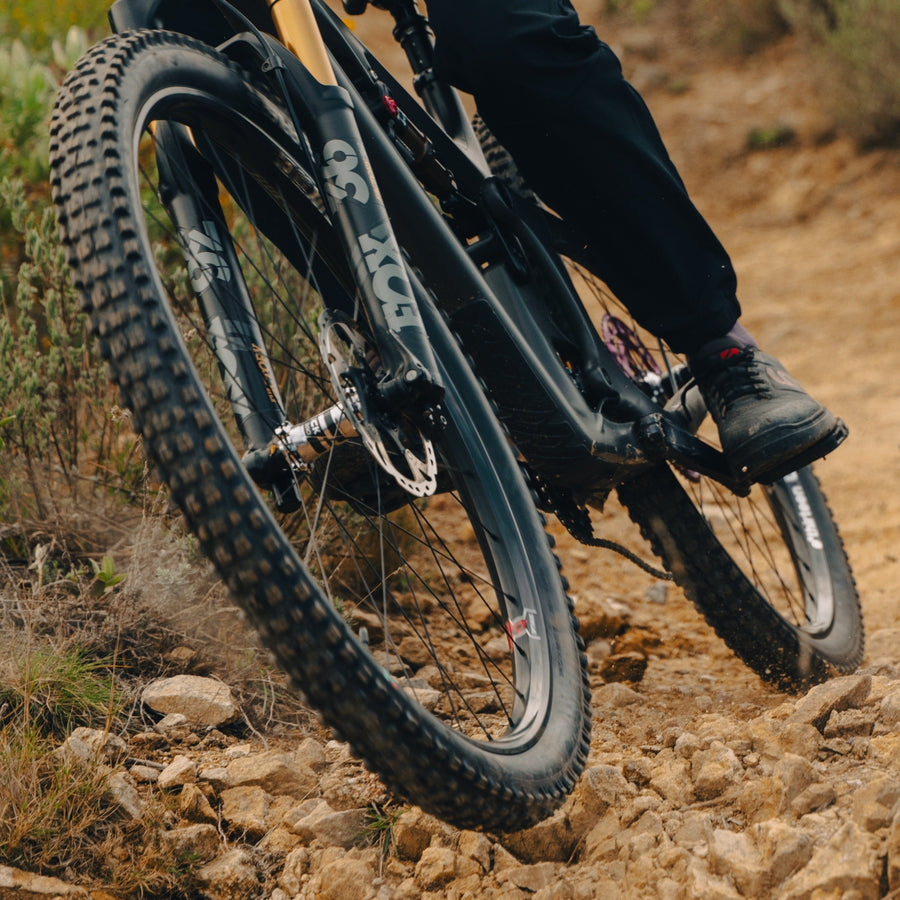 A Grappler Radial tire on a rider's bike on a dry trail