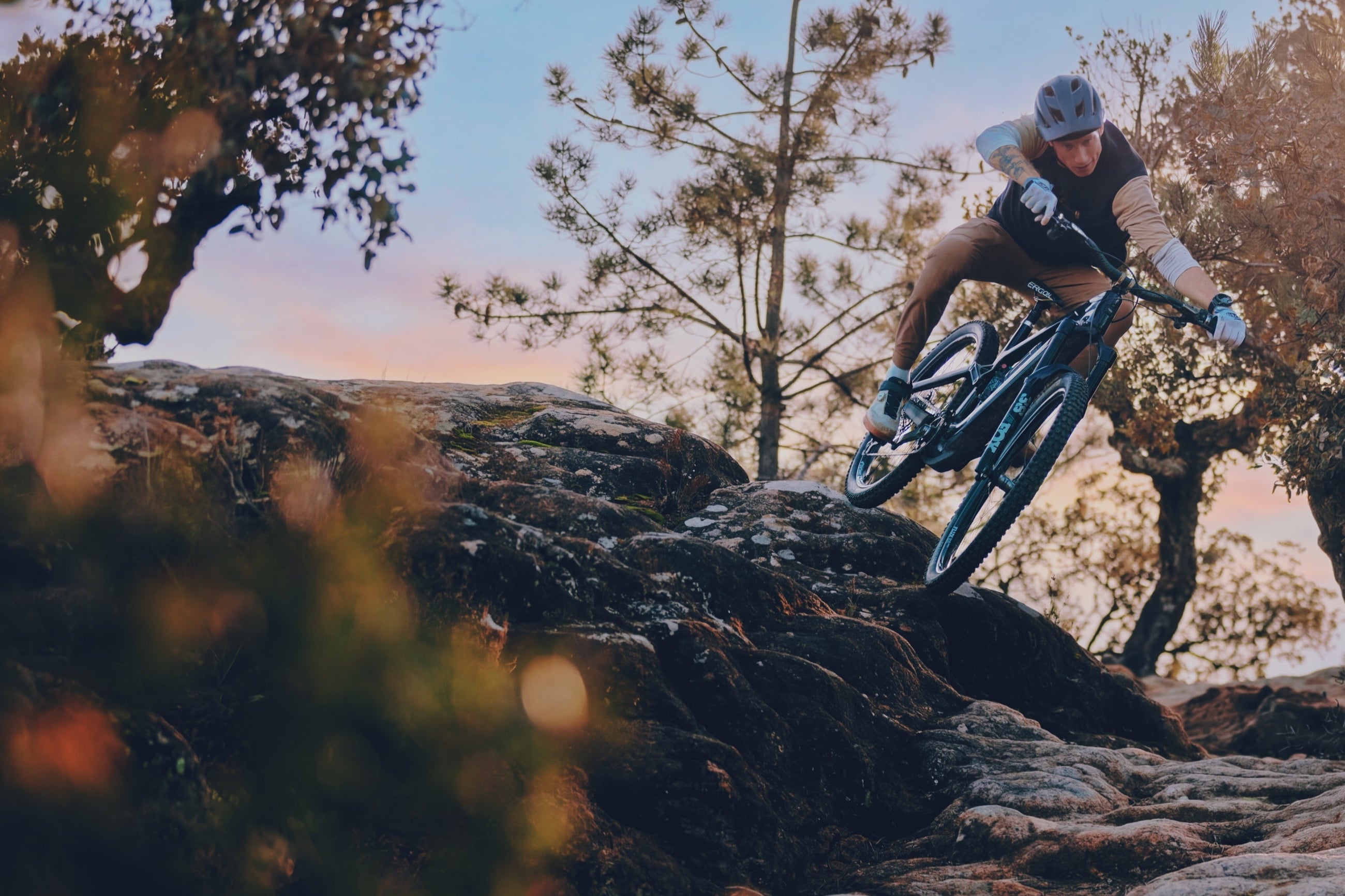 Jasper Jauche dropping into a rock slab on a bike running Sidekick hubs.