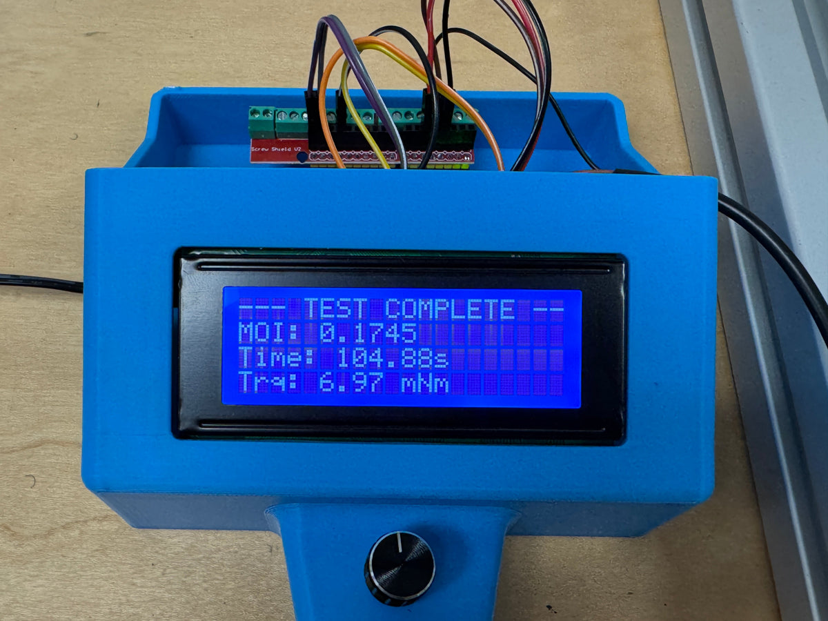 The data logger reading TEST COMPLETE, with the spin-down time and drag torque from a single run.