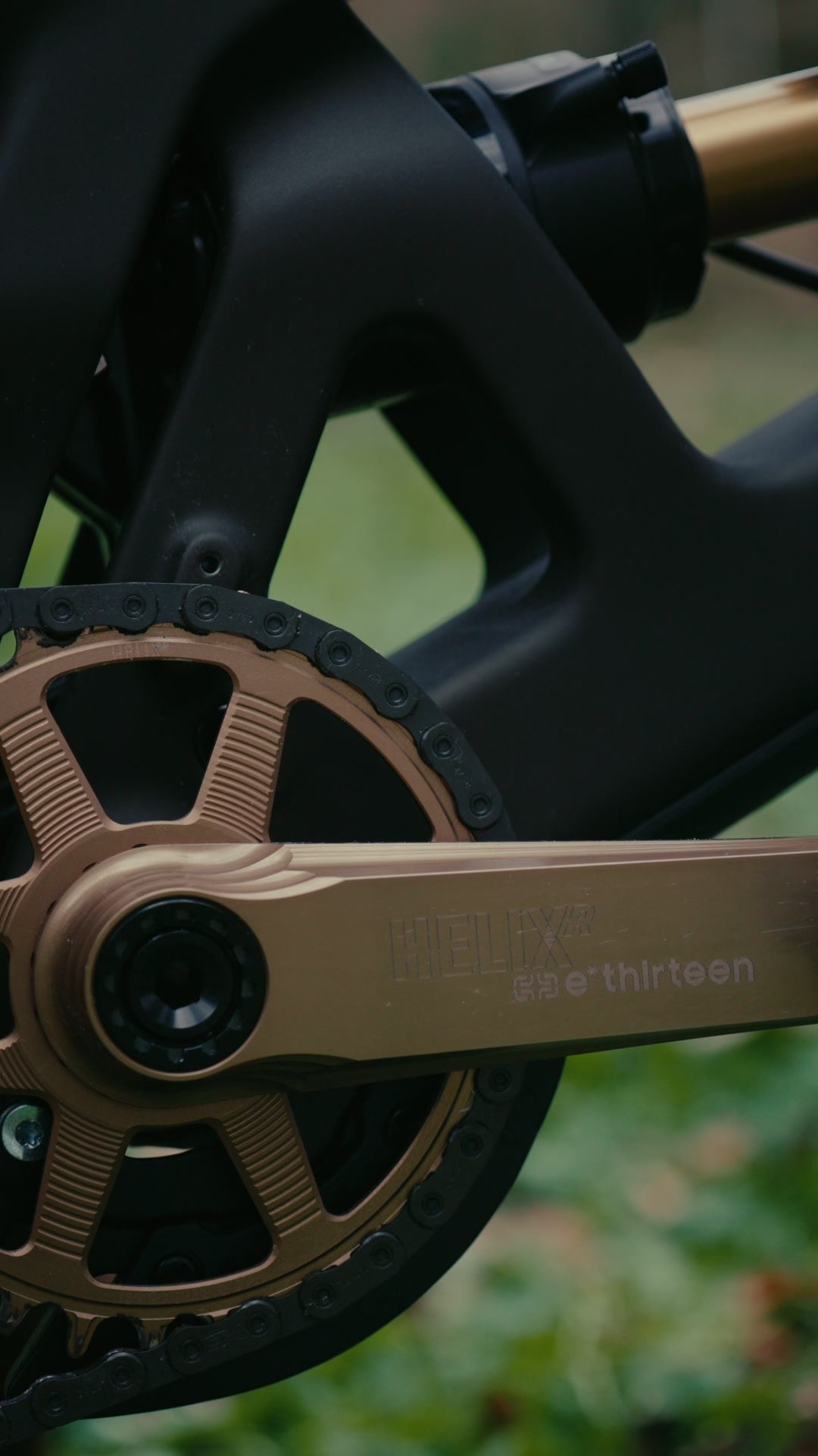 Close up of a bronze Helix Race alloy crank arm and direct mount chainring on Jasper Jauch's Nomad