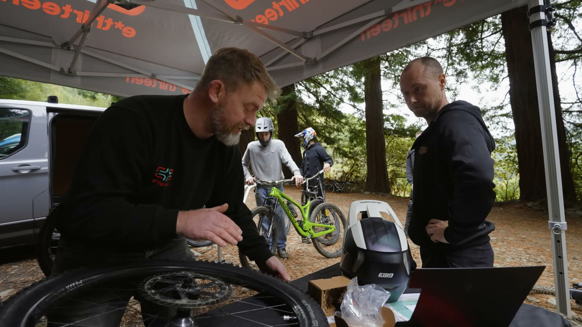 Wheels laid out under the e*thirteen tent while riders wait with their bikes.