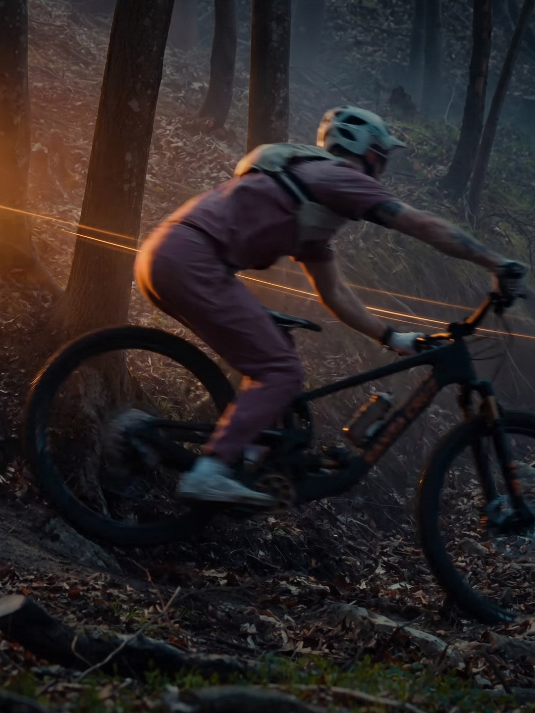 Jasper Jauch riding his Santa Cruz Nomad through a dark forest
